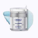 A jar of Obagi Medical Elastiderm Lift Up & Sculpt Facial Moistizer, featuring a clear container with a white lid and silver band, set against a white background with a light blue cream smear behind it.