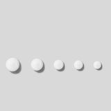 Five white spherical objects on a light gray background