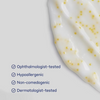 Close-up of a skincare product with text indicating it is ophthalmologist-tested, hypoallergenic, non-comedogenic, and dermatologist-tested.