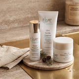 Elume Med Spa Everyday Essentials Bundle featuring cleanser, moisturizer, and tinted sunscreen on a marble tray.