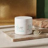 Elume Med Spa Gly/Sal 5-2 exfoliating pads in a white jar on a marble surface with a dried leaf.