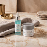 Elume Med Spa Ultra Hydrating Bundle with hyaluronic acid serum and lightweight moisture dew cream on marble surface