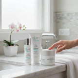 Elume Med Spa Everyday Essentials skincare bundle featuring cleanser, moisturizer, and tinted sunscreen on a bathroom counter.