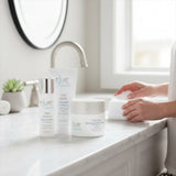 Elume Med Spa Everyday Essentials Bundle featuring cleanser, moisturizer, and tinted sunscreen on a bathroom counter.