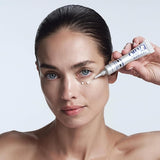 Woman having a cosmetic procedure with a medical device on a white background